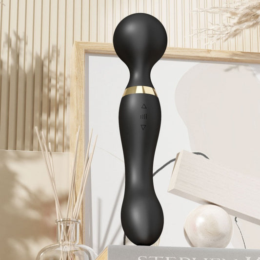 Black handheld device with gold accent on a neutral background
