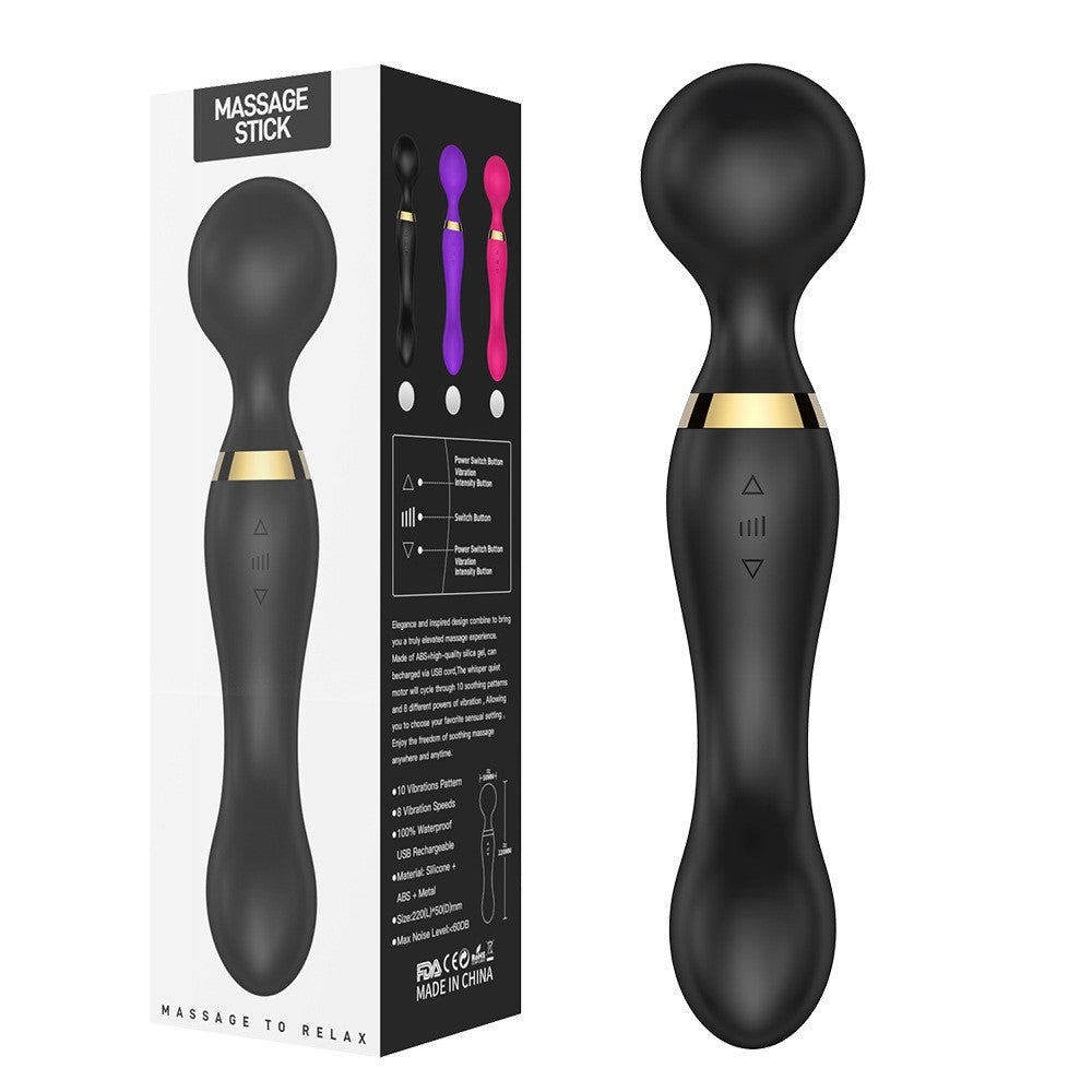 Black massage stick with gold accents and packaging on a white background